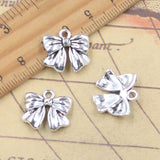 10 Uds. De dijes con lazo, cinta de 16x17mm, colgantes de Color plata antigua, fabricación de joyería tibetana hecha a mano DIY